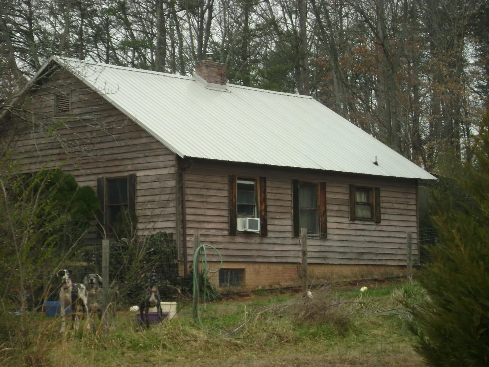 White metal roof on an old wood sided farmhouse, from a Metal Roof Installation job in Middlebranch
